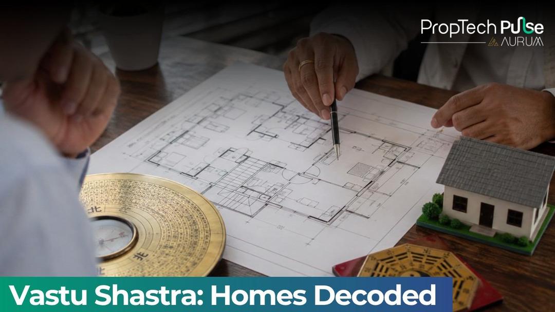 Real estate floor plan consultation showing Vastu-inspired home layout, directional compass, house model, and architectural planning