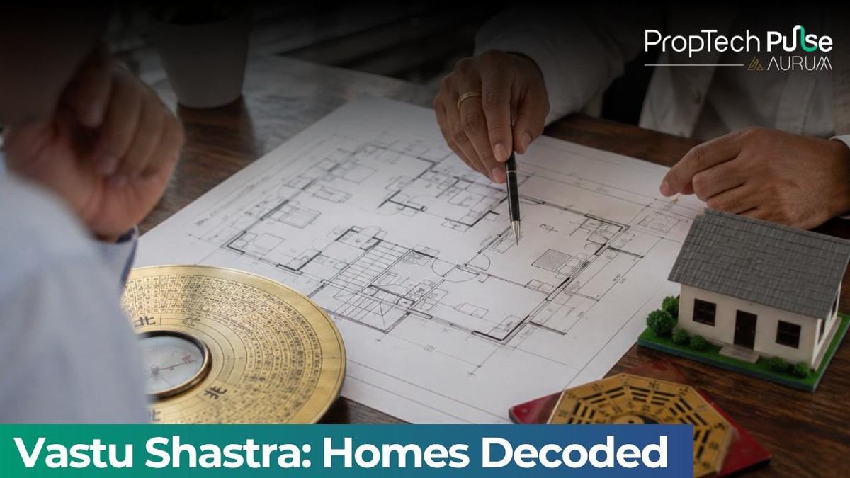 Real estate floor plan consultation showing Vastu-inspired home layout, directional compass, house model, and architectural planning