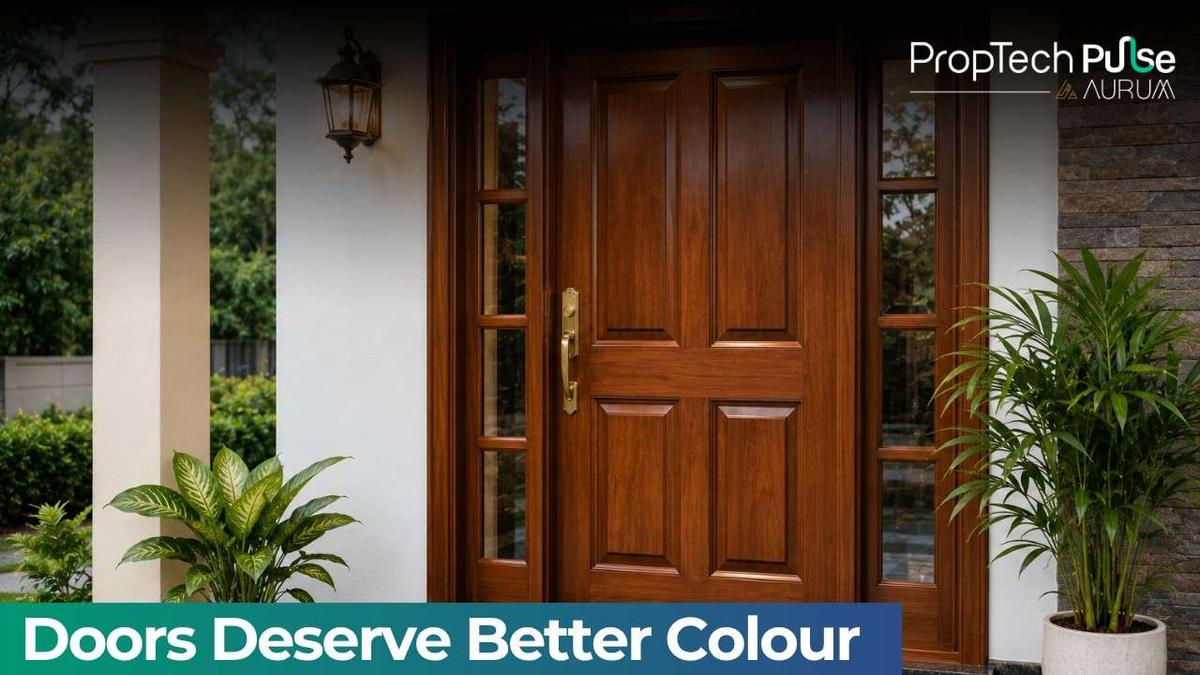 Elegant wooden front door with a rich teak finish, modern panel design, warm exterior lighting, decorative plants, and a stylish contemporary home entrance